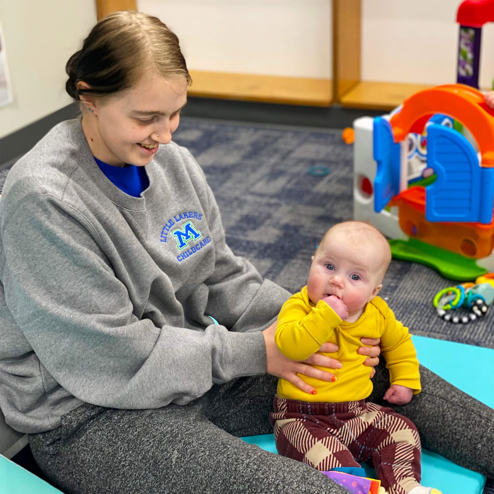 Provider and baby playing with toys